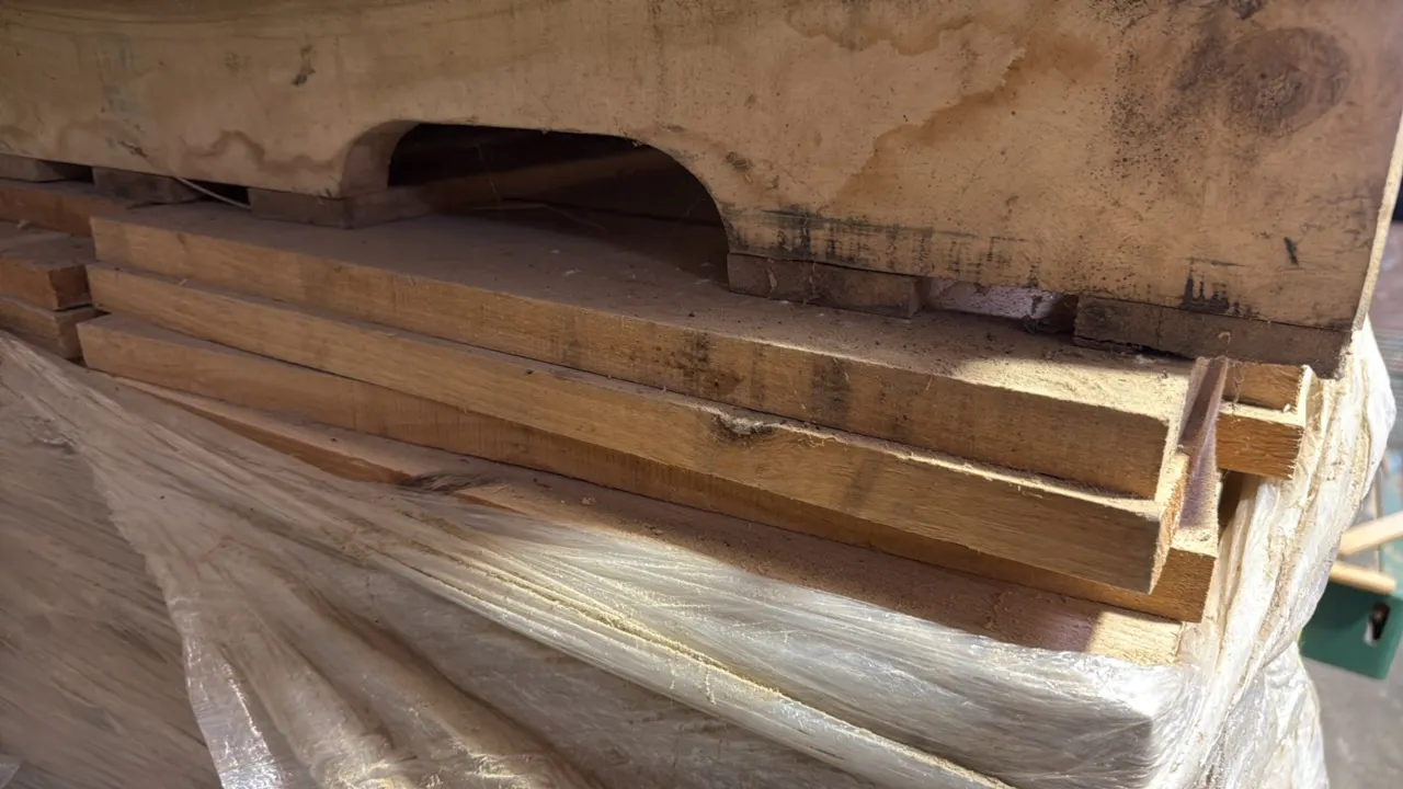 Cutoff hardwood boards on pallet. Pallet stack measures 20"H of approximately 21" x 1" boards. Stretch-wrapped on wooden pallet.