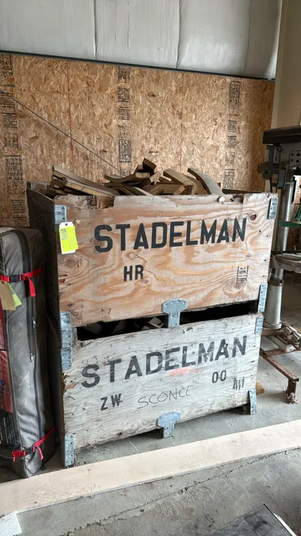 Wooden pallet bin crates with assorted curved wood staves and cutoff pieces. Features Stadelman labeled wooden storage crates with reinforced metal co