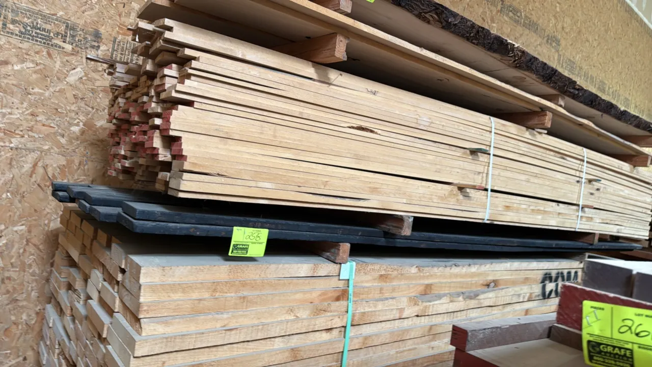 Assorted blackened wood boards. Note: Surrounding lumber not included.
