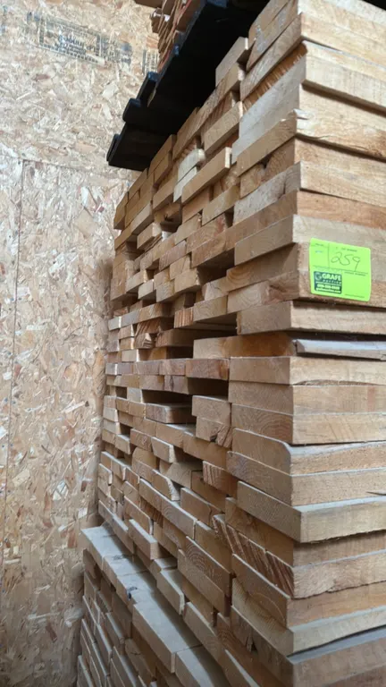 Skid of assorted alder wood boards. Features 1.5" thick rough-cut lumber, banded on pallet. Dimensions: approximately 10' x 3'7" x 3'6"H.