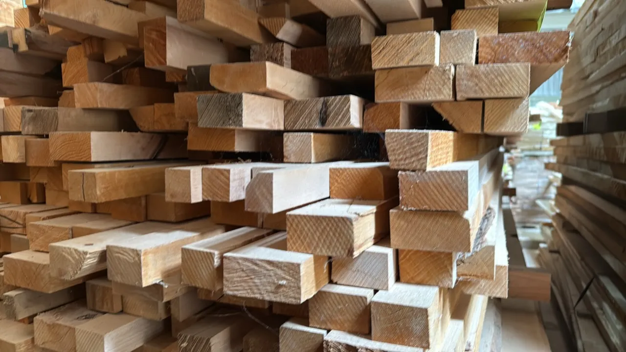 Skid of assorted wood lumber boards. Features assorted cuts, profiles, and thicknesses. Approximately 10' x 3' x 2'H. Surrounding lumber and racking n