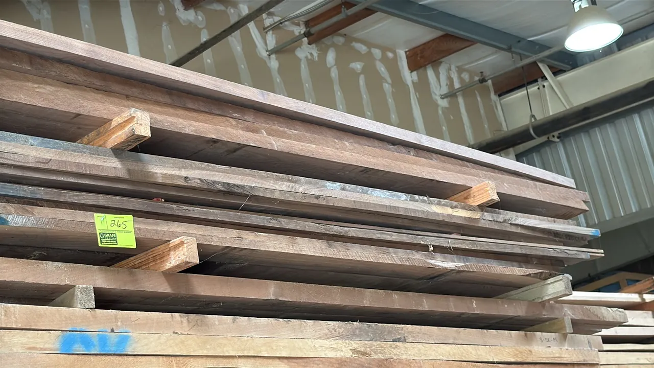 Skid of assorted wood boards. Features hardwood lumber boards in assorted thicknesses and lengths with color-coded sealed ends. Approximately 9'L x 3'