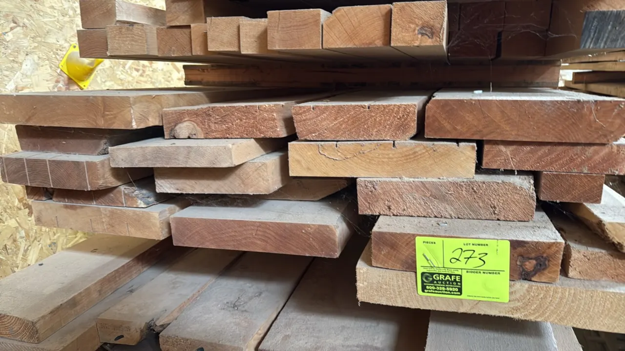 Assorted wood lumber boards. Features various board thicknesses and widths on a skid. Approx. 10'L x 3'W x 1'H.