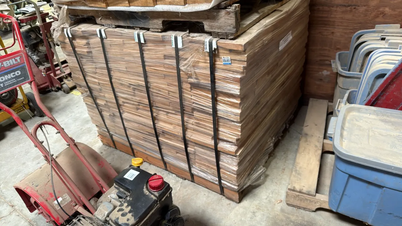 Pallet of cut wood stock boards. Marked 1" x 9" x 40" Premium. Banded and stretch-wrapped on a wooden pallet.