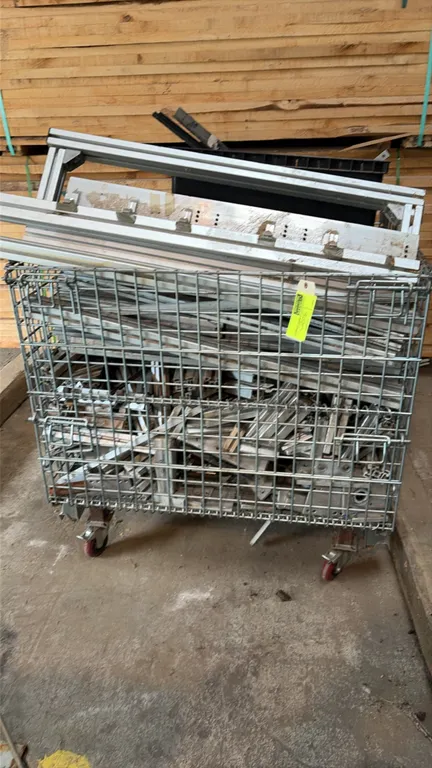Portable metal wire dump bin with metal contents. Features wire mesh container construction with a 4,000 lb capacity rating plate. Includes contents c