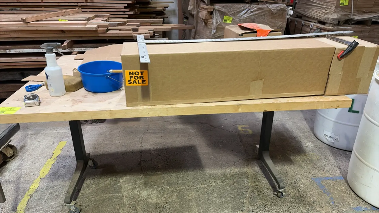 Portable work table. Features a wood top on a metal base. 6'L. Mounted on casters. Contents not included.