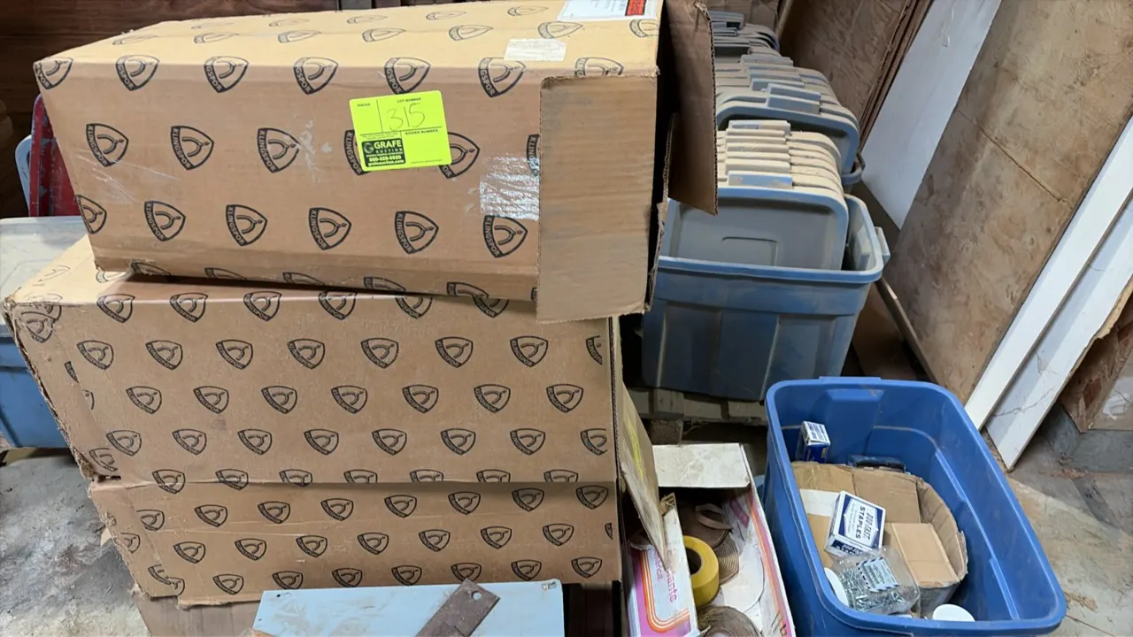 Assorted sandpaper and abrasive sanding belts. Includes multiple boxes of Klingspor sanding belts and rolls of sanding abrasives.