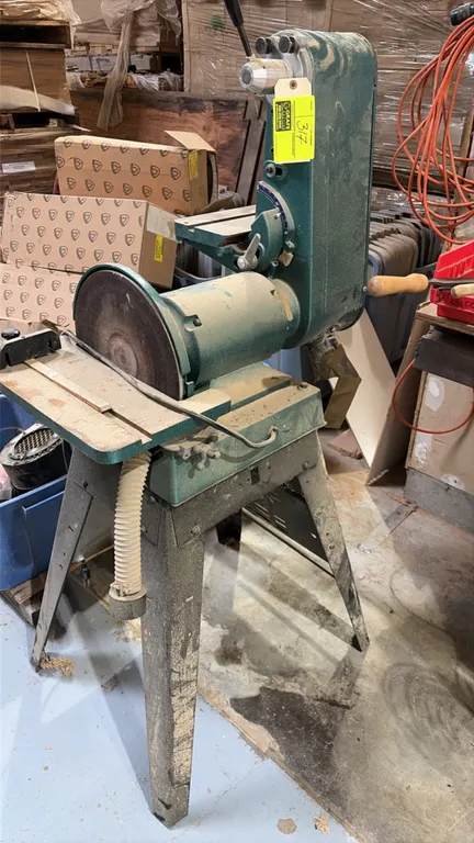 Grizzly G-1183 belt sander-grinder. Features 6" x 48" belt sander, 12" sanding disc, work support tables, and push-button power switch. 1 HP, 3450 RPM