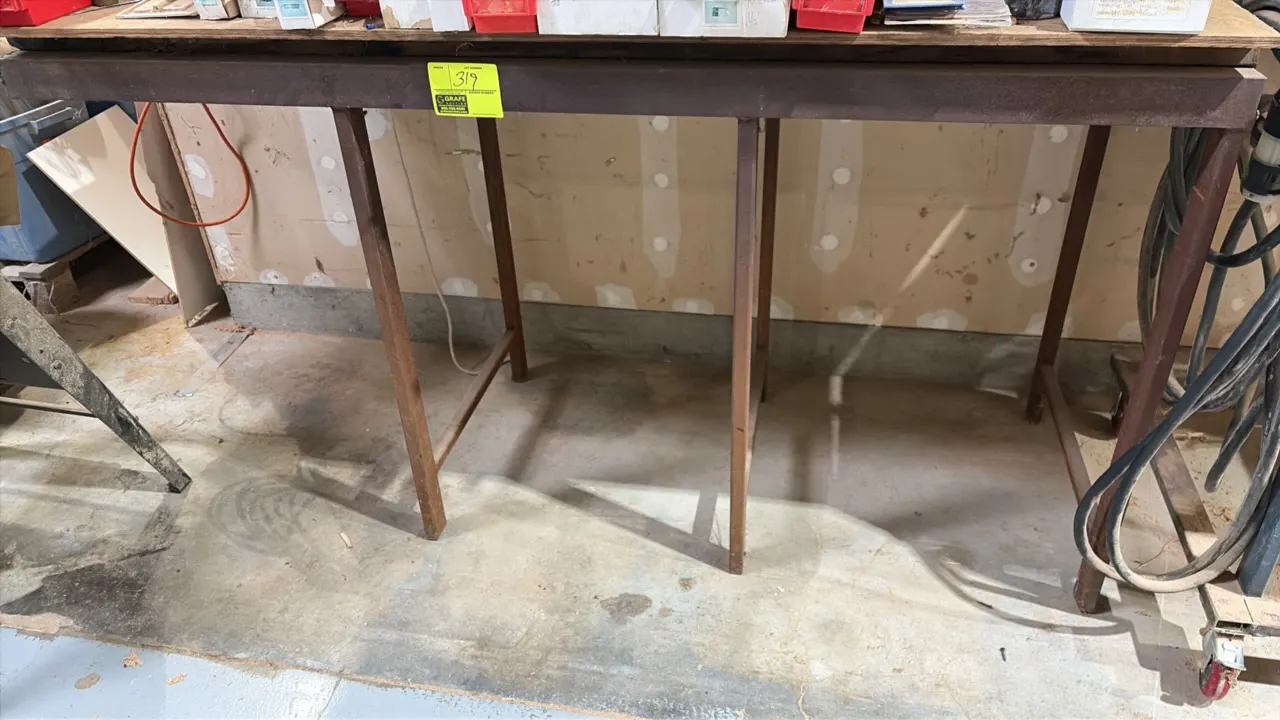 Work table with wood top and metal frame base. 70" x 24". Contents not included.