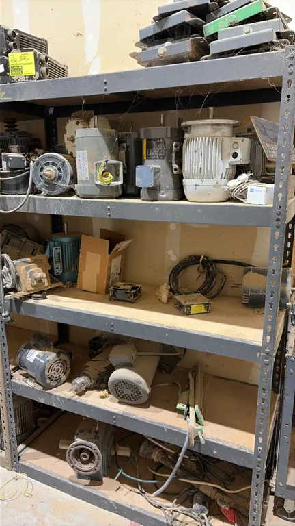 Assorted electric motors and hardware. Includes various electric motors, gear reducers, mounting plates, wiring, and replacement components across 5 s
