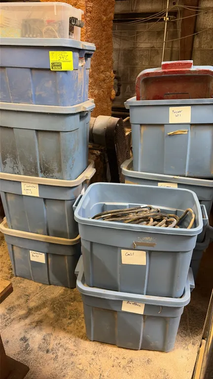 Assortment of electrical parts and components in plastic storage totes. Includes wiring, cables, contactors, and miscellaneous hardware.