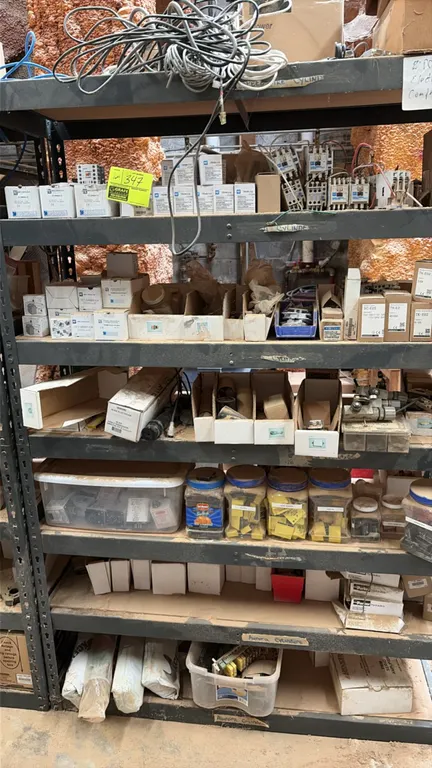 Assorted industrial and electrical replacement parts. Includes contactors, relays, cabling, hardware, pneumatic components, and plastic storage contai