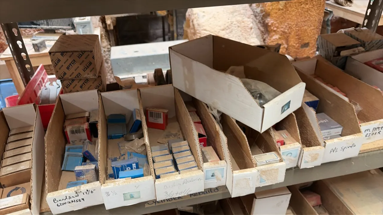 Assorted hardware, bearings, and replacement parts. Includes 3 shelf rows of parts bins containing assorted bearings (AMI, Koyo, Fafnir), bushings, co