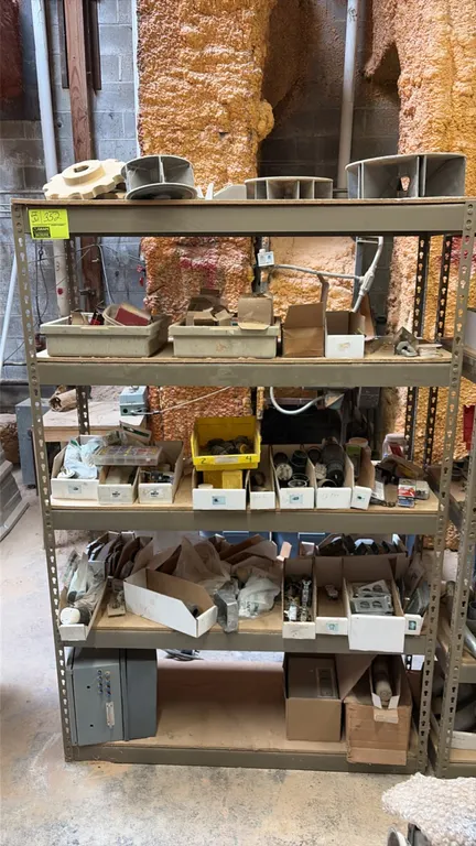 5-tier metal storage rack with assorted electrical components. Features steel frame construction with wood decking. Includes assorted electrical parts