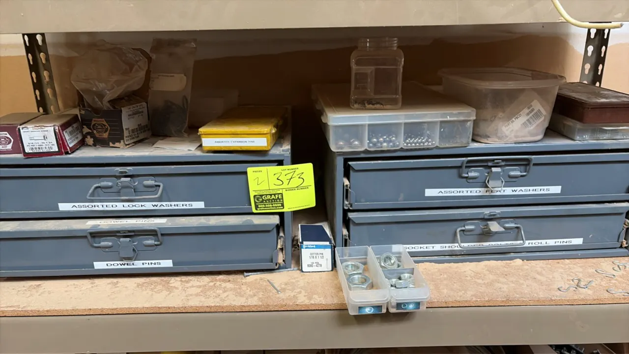 Metal parts storage drawer cabinets with assorted hardware. Includes lock washers, flat washers, dowel pins, roll pins, nuts, bolts, and assorted fast