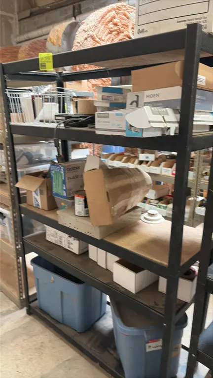 5-tier metal storage shelving rack with particleboard decking. Includes miscellaneous parts and contents as pictured. Dimensions: 48" x 18" x 72".