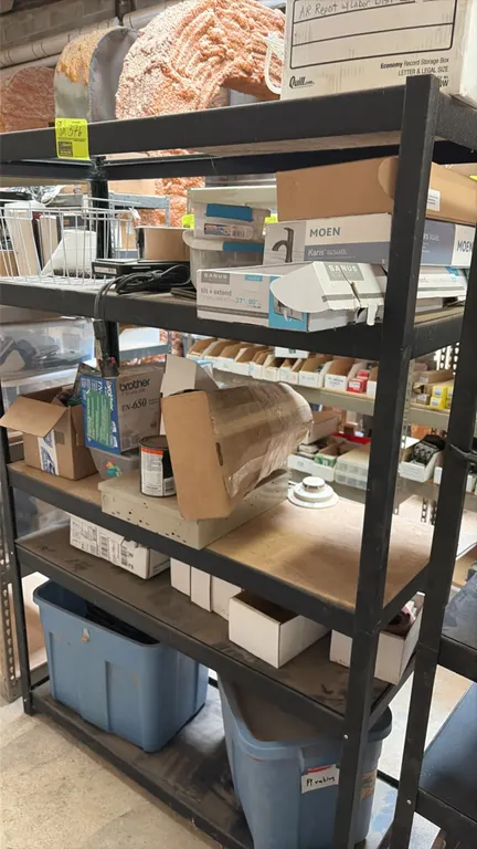 5-tier metal storage shelving rack with particleboard decking. Includes miscellaneous parts and contents as pictured. Dimensions: 48" x 18" x 72".