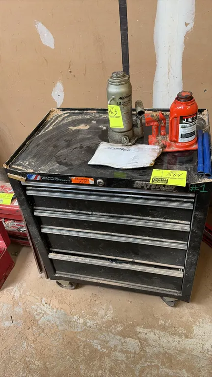 Waterloo 4-drawer portable tool cart. Features metal construction, black finish, full-width drawer pulls, and integrated lock. Mounted on casters. Con