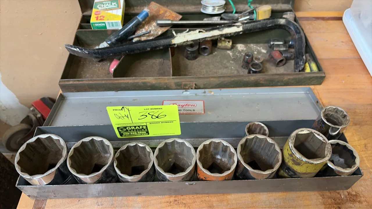 Craftsman assorted metric sockets, hand tools, and hardware. Includes large-drive sockets, socket extension, pry bar, and miscellaneous parts. Housed