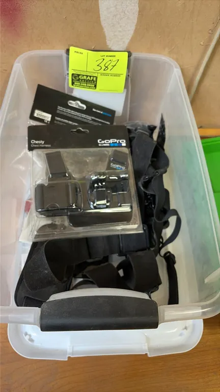 GoPro camera mounting accessories and straps. Includes GoPro Chesty chest harness in retail packaging along with assorted mounting straps and harness