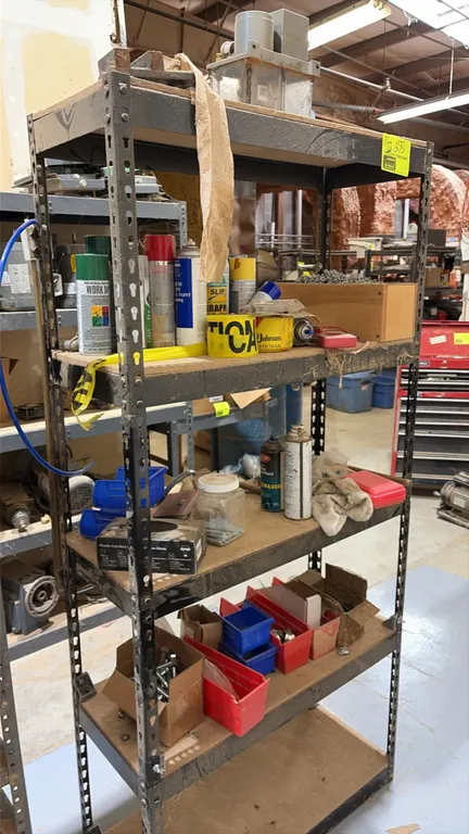 Metal storage shelving racks. Features multi-tier adjustable shelves. Includes assorted hardware, fasteners, small parts, supplies, and plastic organi