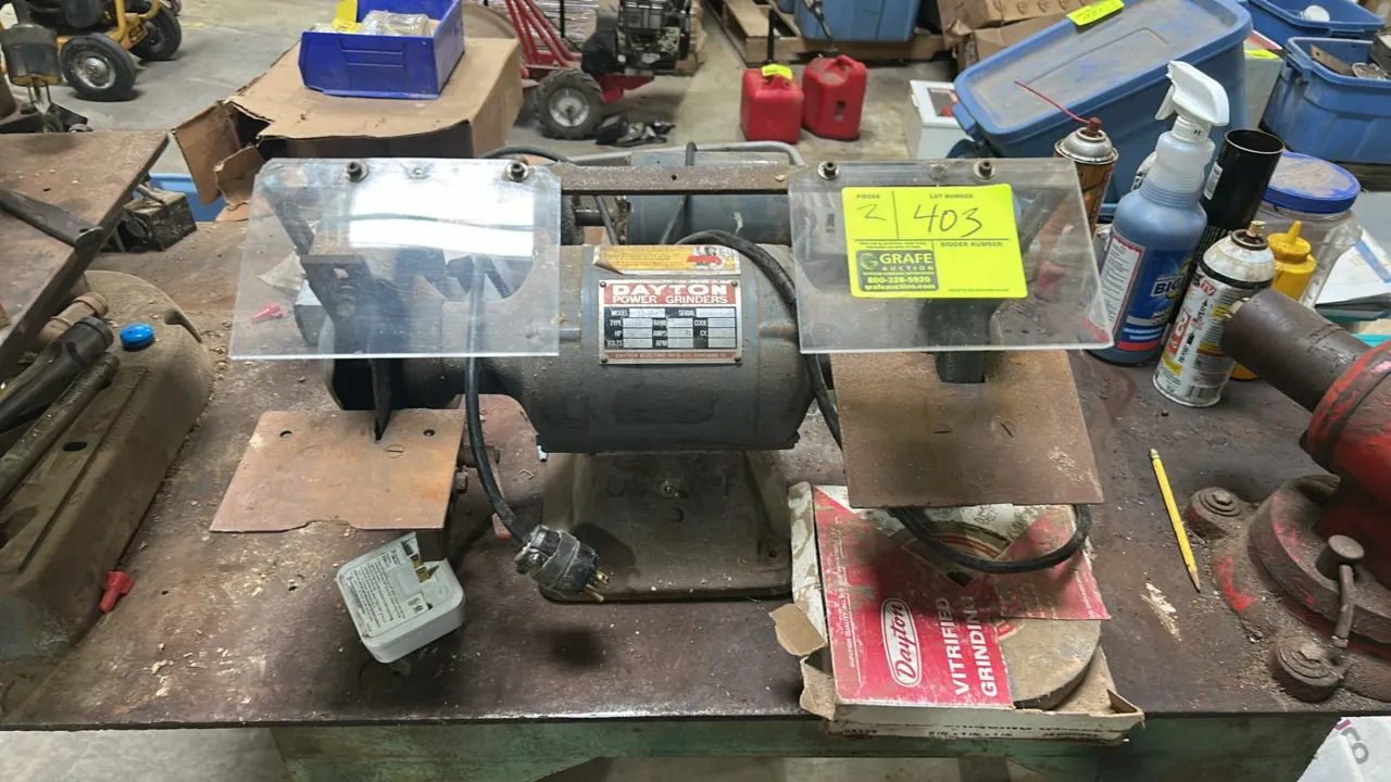Dayton 1Z-707 bench grinder and benchtop buffing setup. Includes Dayton 3/4 HP bench grinder with clear eye shields, extended tool rests, extra vitrif