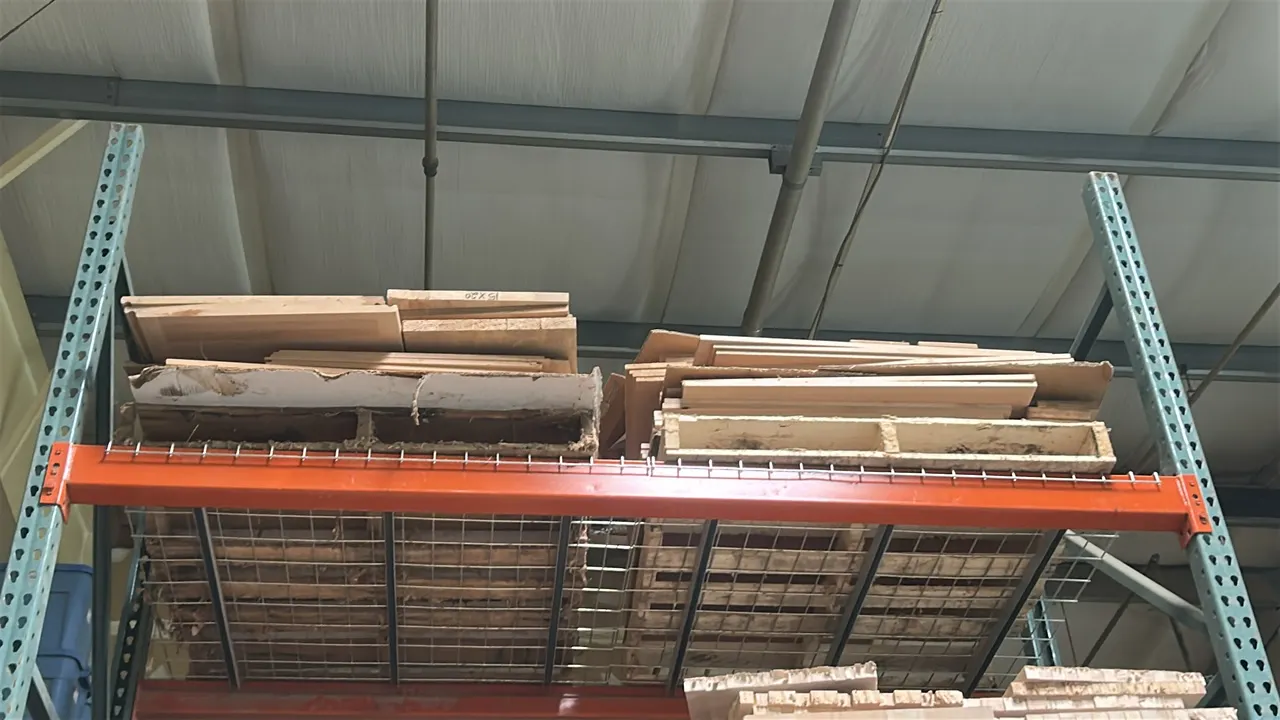 Glued maple wood panels. Includes panels arranged across (2) wooden pallets on the top shelf level. Pallet racking and additional lumber shown not inc