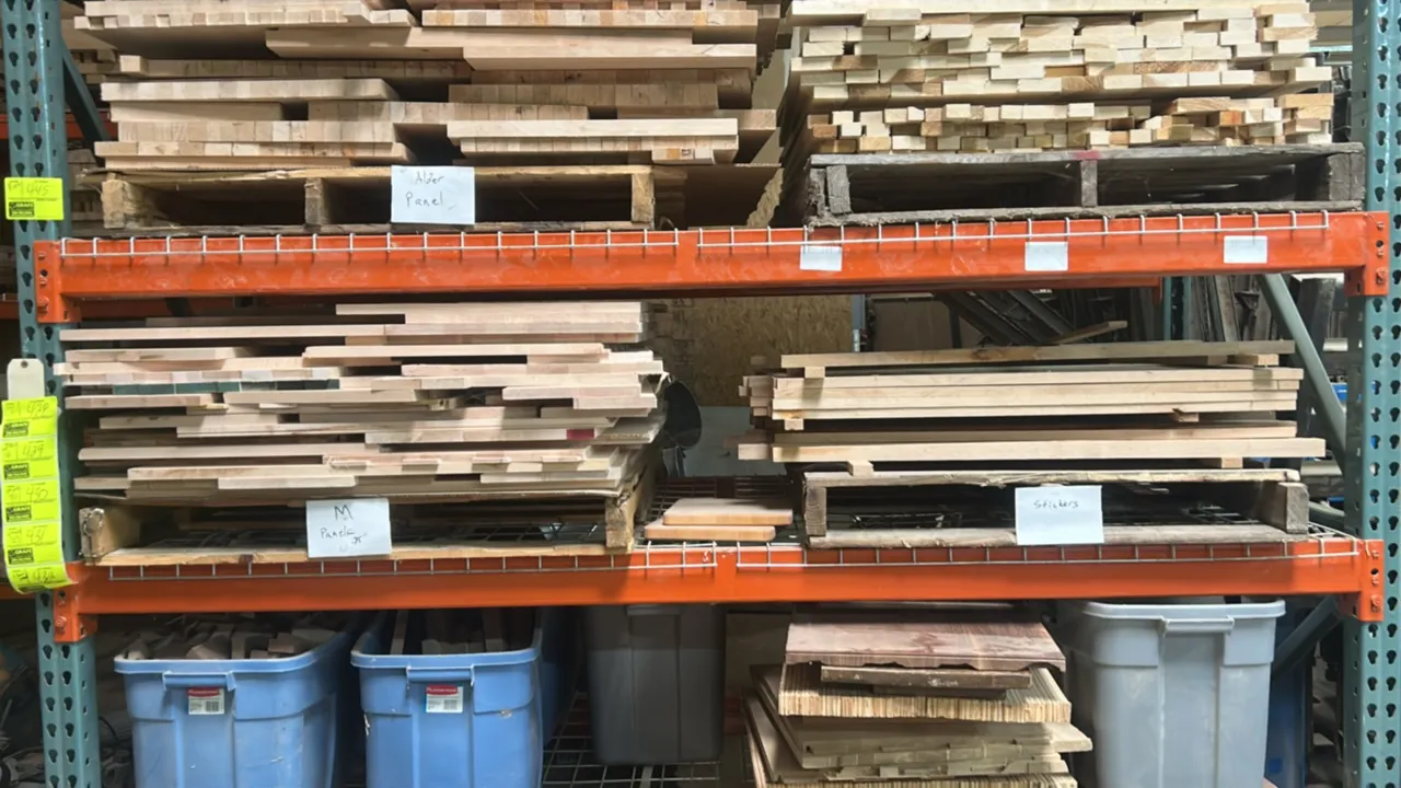 Pallet lot of glued maple wood panels. Features assorted edge-glued maple panels and boards. Panel thickness: 0.75". Pallet racking and surrounding it