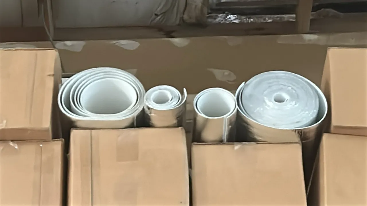Assorted insulation materials. Includes rolls of foil-faced reflective insulation and boxed items located on the top shelf. Pallet racking not include