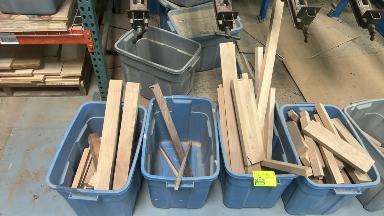 Assorted hardwood lumber and cutoffs. Features various lengths, dimensions, and species contained in plastic storage totes.