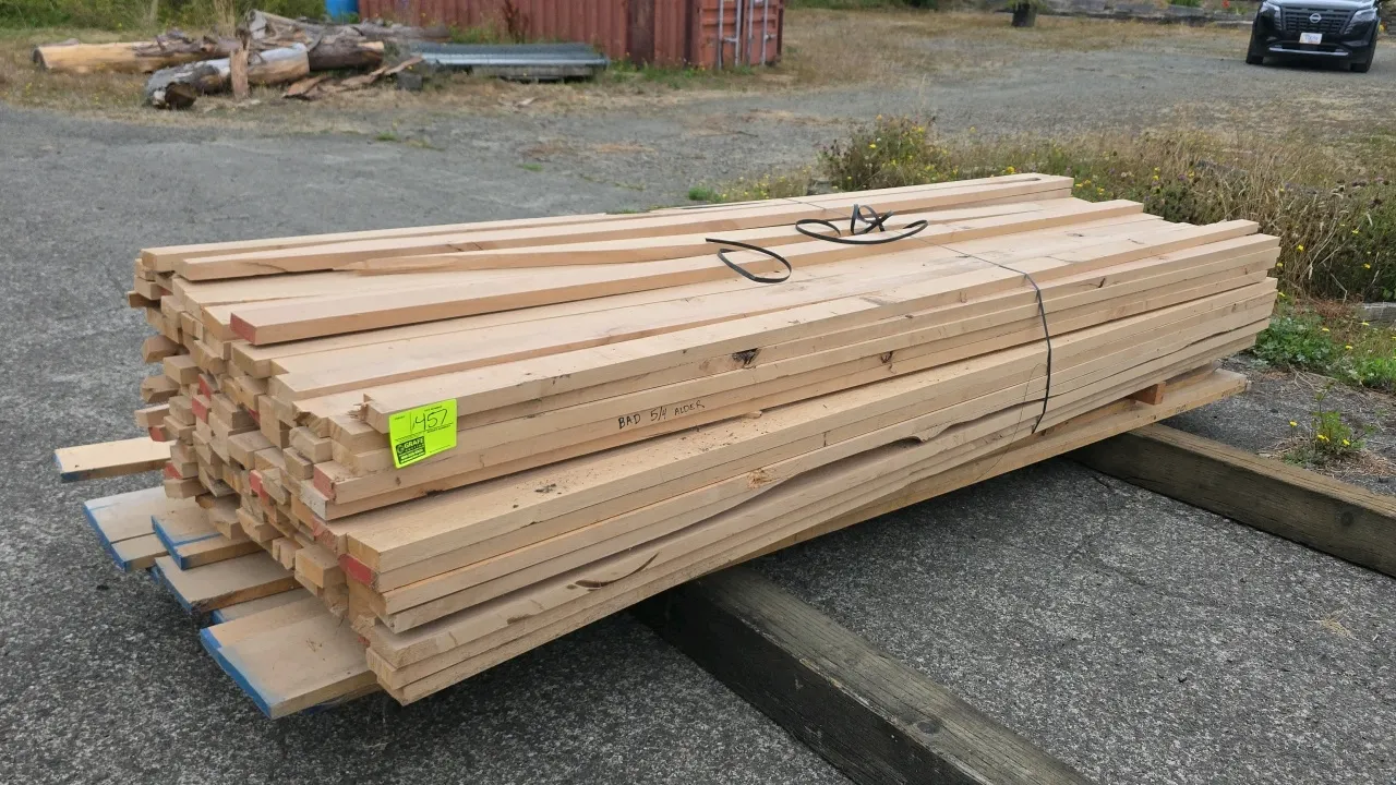 Bundle of alder lumber. Features mixed rough-cut boards. Approx. 10'L with 1" to 1-1/4" board thickness.