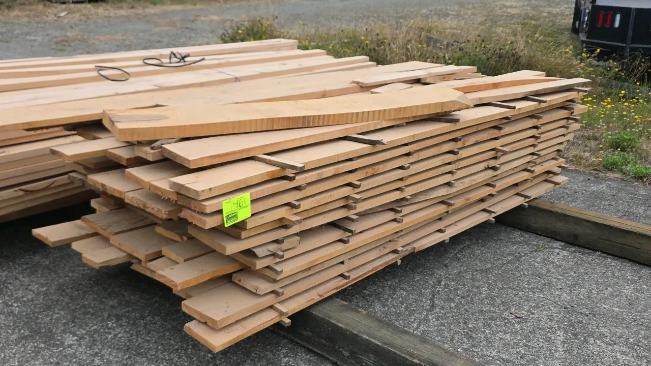 Stack of hardwood lumber boards. Features stickered layers with rough-sawn finish. Includes assorted length cuts on top. Dimensions: Approx. 8'8"L x 1