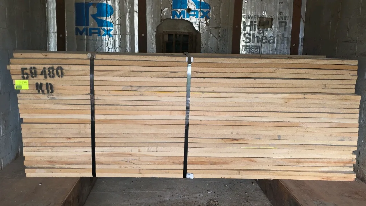 Bundle of sycamore hardwood lumber. Marked KD (kiln-dried). Tag indicates 1,430 board feet. Approximately 10'L with 1-1/2" thick boards. Strapped with