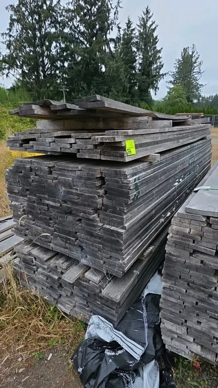 Hardwood lumber bundle. Stack of boards measuring approx. 10'L x 1" thick.
