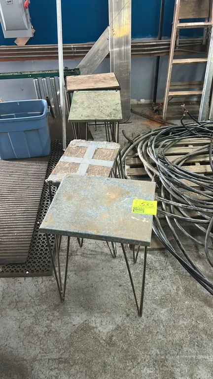 Metal hairpin leg display stands. Features assorted metal and wood tops mounted on wire hairpin legs.