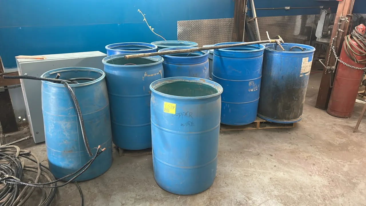 Assorted electrical wires, heavy-gauge cables, and cords. Includes (8) blue poly drums, plastic storage totes with lids, electrical enclosure box, cab
