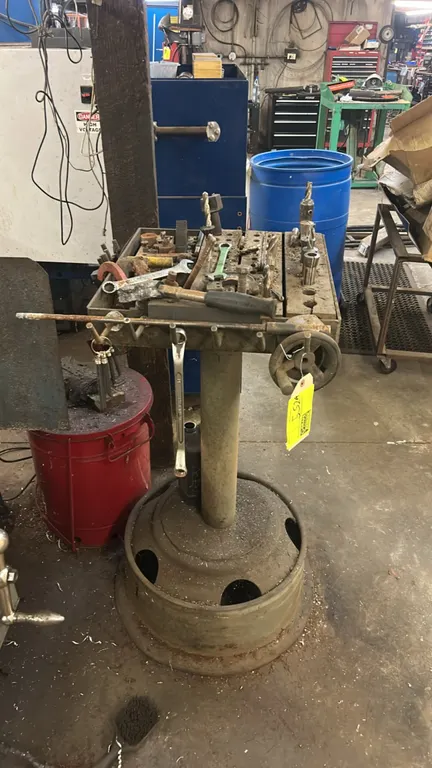 Metal tooling stand with assorted machining contents. Includes drill bits, end mills, collets, hand wrenches, clamping kit hardware, and lead hammer.
