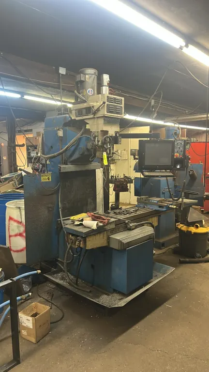 Southwestern Industries TRAK DPM Series CNC bed mill. Features interactive CNC control console with keyboard, Kurt precision milling vise mounted to w