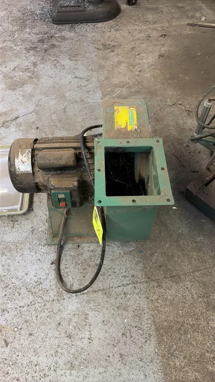 Sunhill Machinery dust collector blower. Features an integrated electric motor, push-button power switch, metal impeller housing, and flanged exhaust