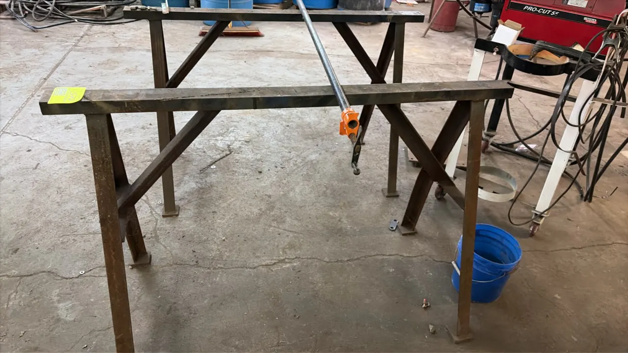 Metal sawhorses. Fabricated welded steel construction with angled leg bracing and foot pads. 4'L. Pipe and clamp resting on units not included.