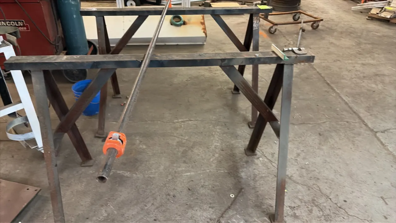 Metal sawhorses. Fabricated welded steel construction with angled leg bracing and foot pads. 4'L. Pipe and clamp resting on units not included.