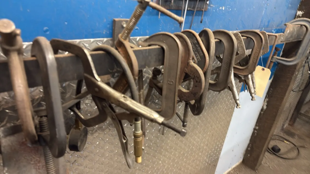 Assorted C-clamps and locking C-clamps. Includes various sizes and styles of heavy-duty metal clamps. Mounting bar and background items not included.