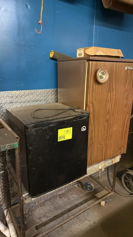Compact refrigerators. Includes (1) Igloo black countertop refrigerator and (1) Sanyo woodgrain-finish undercounter refrigerator. Features upper chill