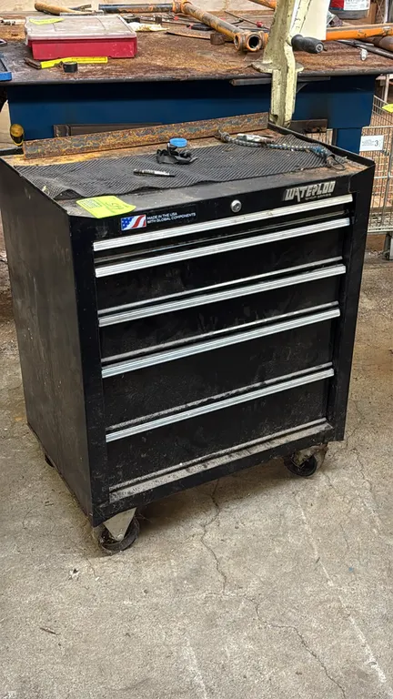 Waterloo Shop Series 5-drawer rolling tool cabinet. 26.5"W. Features locking drawers, full-width drawer pulls, and top rubber mat. Includes an assortm