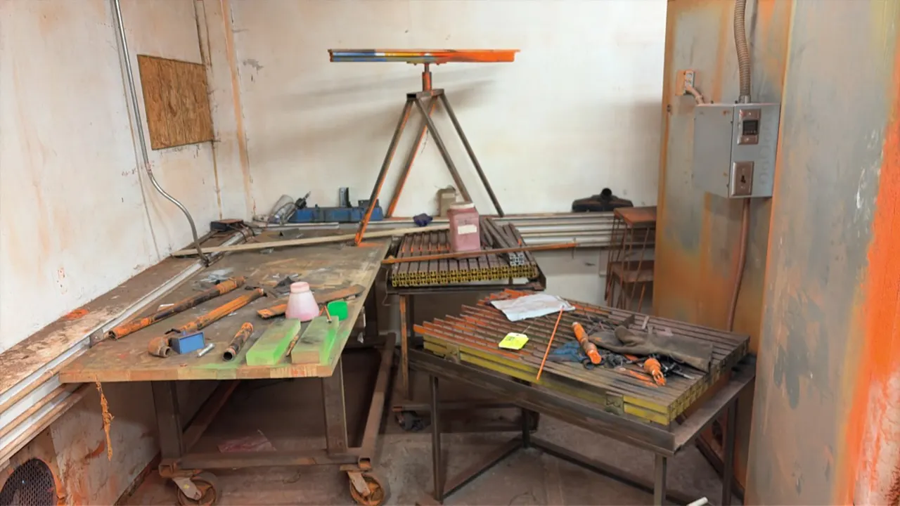 Metal portable tables with assorted metal stock. Includes steel mobile work tables mounted on casters and metal stands. Fabricated steel tube frame co