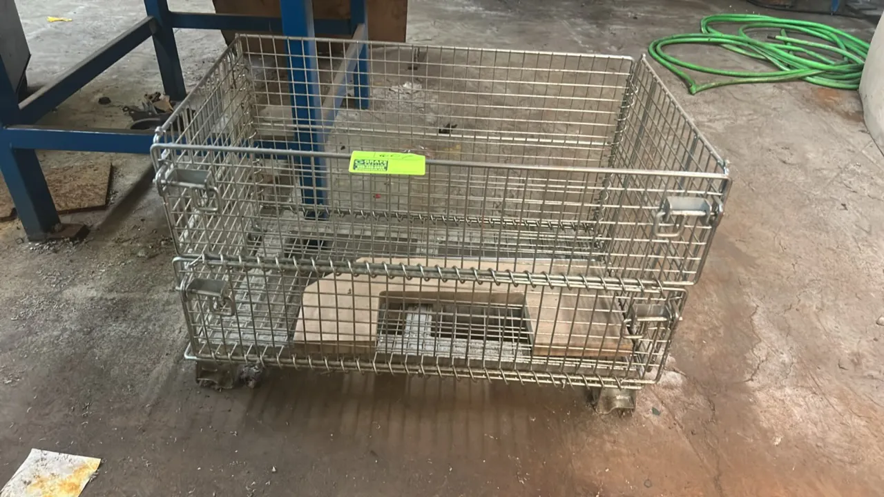 Metal wire collapsible storage crate. Features open wire mesh construction, front drop-down gate with latches, and integrated base feet for stacking.