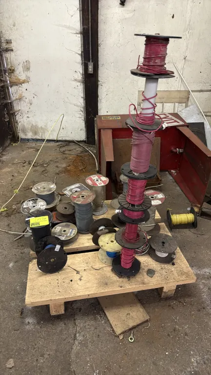 Assorted electrical wire spools. Includes various partial and full spools of insulated electrical wire in multiple colors, gauges, and reel sizes.