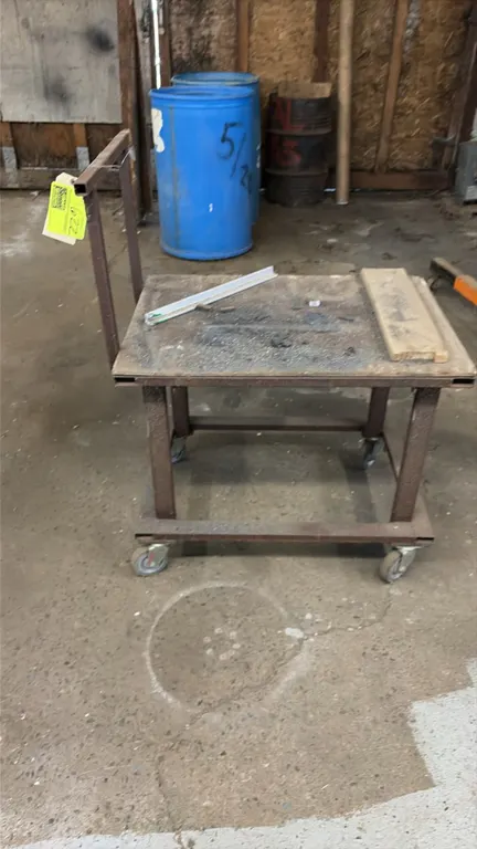 Mobile steel utility cart. Features welded steel construction, wood top work surface, and integrated push handle. Mounted on (4) swivel casters. Conte