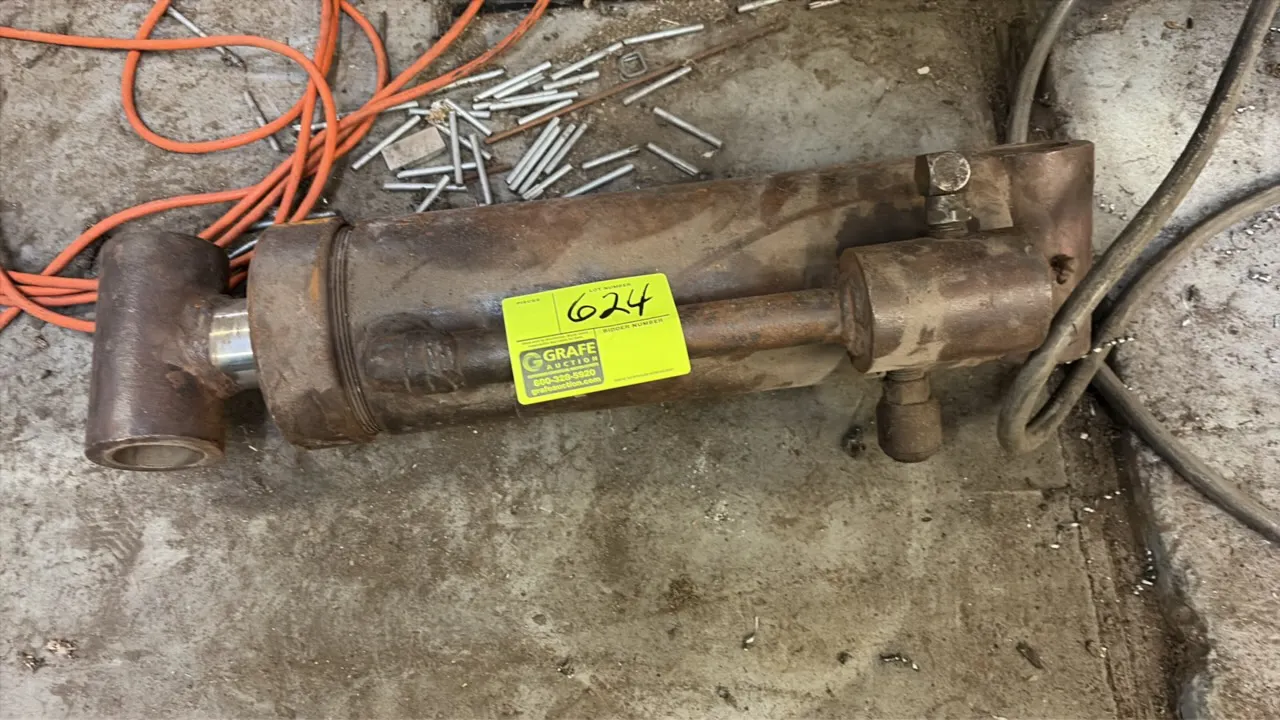Hydraulic cylinder. Features cross-tube mounting ends and integrated hydraulic line assembly.