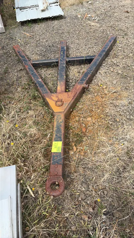 Steel trailer tongue hitch. Features welded tubular steel A-frame construction, lunette ring pintle coupler, and top D-ring attachment point.